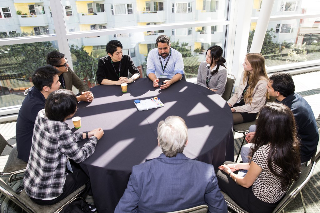 A group networking during TechCrunch Disrupt
