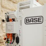 A Base Power battery sits next to a home.