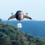 Airbound drone in flight carrying payload