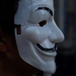 A member of the international organisation Anonymous for the Voiceless wears a Guy Fawkes mask while demonstrating in the streets of Mexico City's Historic Center.