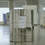 A can of electrolyte sits on a factory floor.