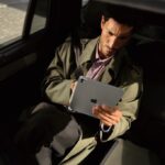 man looking at Apple tablet
