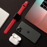 Flat Lay of different apple products on a dark grey background.