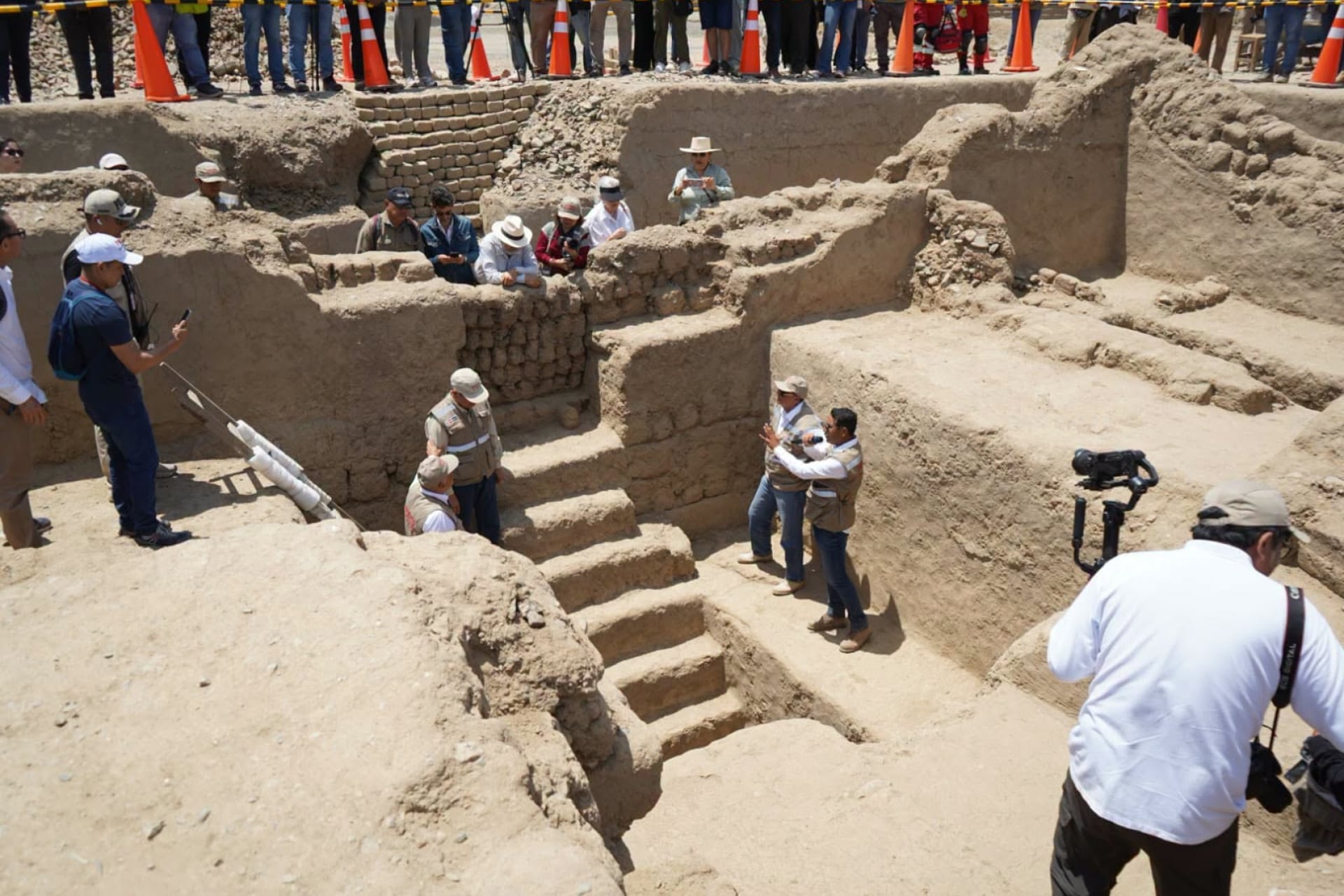 Archaeologists stand at the entrance to a Chimú-era mausoleum discovered at the Utzh An complex in Chan Chan.