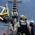 U.S. Coast Guard troops scaling ladder