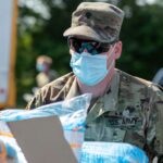 A member of North Carolina’s Army National Guard loads sterile shoe covers onto a truck while delivering personal protective equipment to medical facilities in the southeastern state back in 2020.
