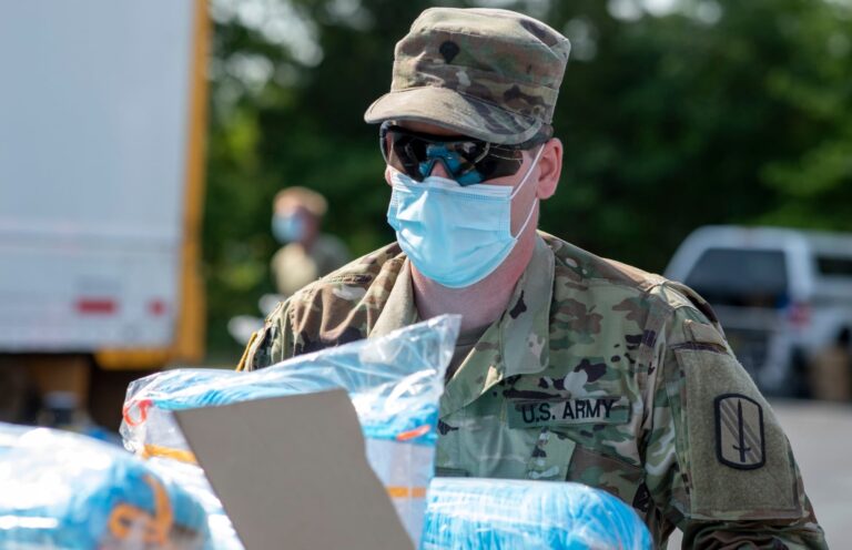 A member of North Carolina’s Army National Guard loads sterile shoe covers onto a truck while delivering personal protective equipment to medical facilities in the southeastern state back in 2020.