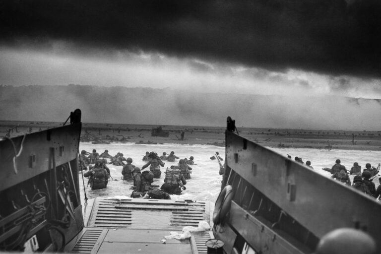 A landing craft from the USS Samuel Chase unloads Allied troops onto the Fox Green section of Omaha Beach in northern France under moody skies on the morning of D-Day, June 6, 1944.