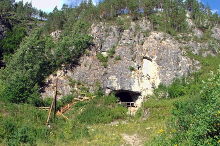 Entrance to Denisova Cave in Siberia, Russia, where Denisovans were first identified. New discoveries in China are adding important details to our understanding of these prehistoric humans.