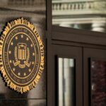 The Department of Justice (DOJ) seal on the J. Edgar Hoover Federal Bureau of Investigation (FBI) building in Washington, DC.