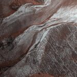 An image of gullies with a sprinkle of frost (shown in white) observed during Martian springtime by the Mars Reconnaissance Orbiter's HiRISE camera in 2019.