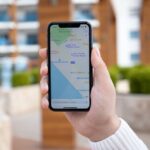 Man hand holding iPhone 11 with Apple Maps on screen