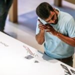 man checking out retail cell phone display