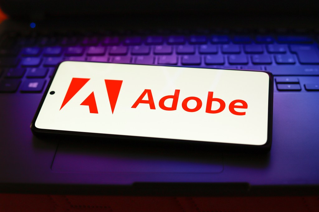 The Adobe Inc. logo displayed on a smartphone screen.