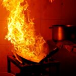 A fire rages in a kitchen.