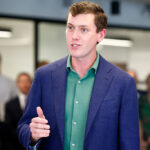Garrett Langley, CEO and co-founder of Flock Safety, speaks during a ribbon cutting for the Seaport District headquarters on July 22, 2025.