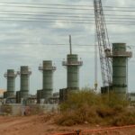 Five smoke stacks stand at a construction site in Texas.