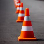 line of orange traffic cones on road