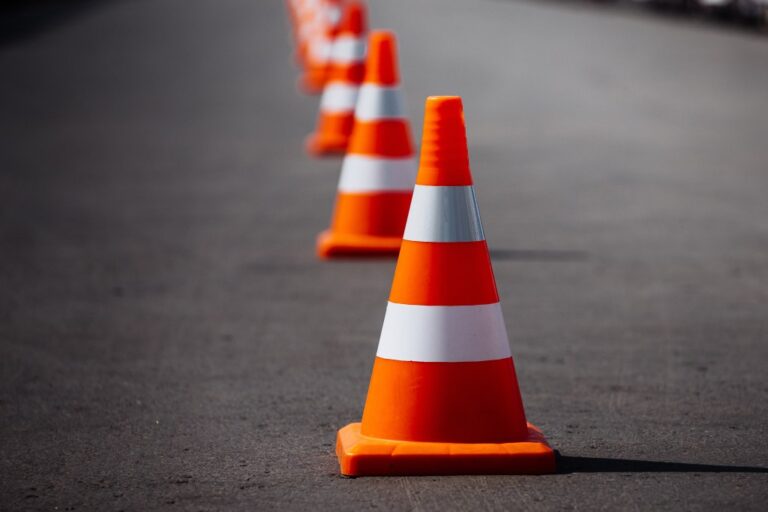 line of orange traffic cones on road