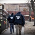 US Immigration and Customs Enforcement (ICE) agents walk down a street during a multi-agency targeted enforcement operation in Chicago, Illinois, US, on Sunday, Jan. 26, 2025.