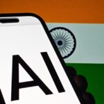 India flag with 'AI' displayed on smartphone screen in foreground