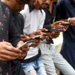 Internet users in India looking at their smartphones