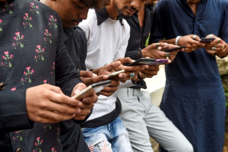 Internet users in India looking at their smartphones