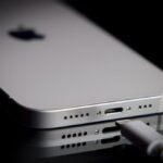 A Apple Lightning port charging cable is seen with with an iPhone.