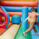 A child playing in a bounce house.