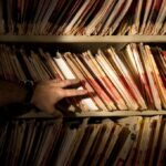 tons of medical records on a shelf in a darkened room