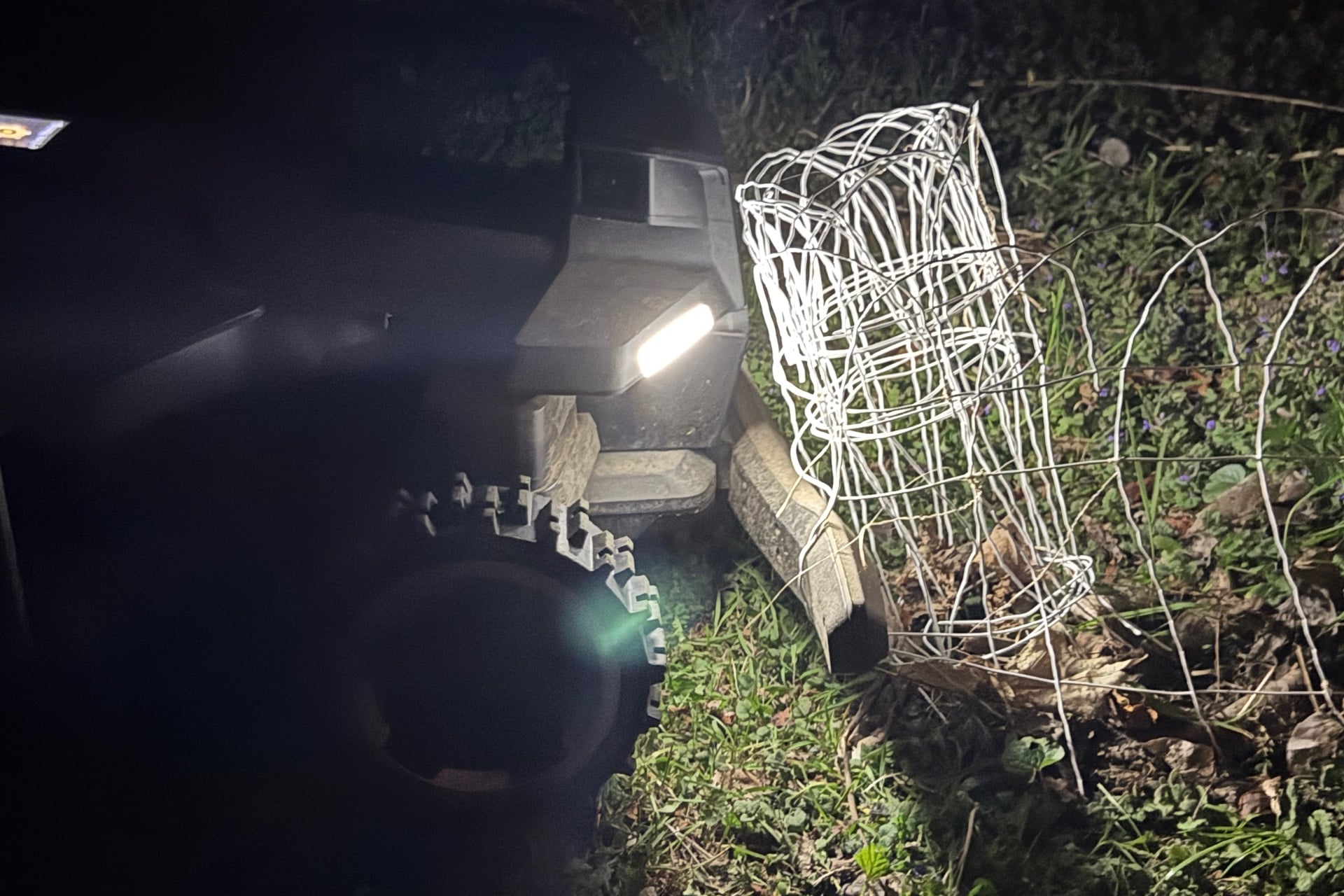 navimow-x430-fence-1 Navimow X430 stuck on a garden fence while mowing at night.