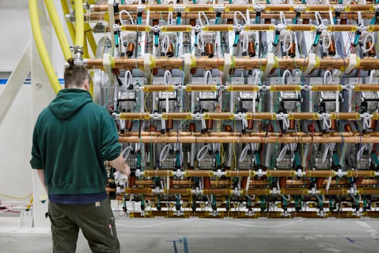 A man works on Pacific Fusion's pulser prototype.