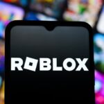 In this photo illustration, the Roblox Corporation logo is seen displayed on a smartphone screen.