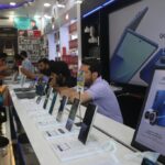 Samsung mobile phones are displayed for sale at an electronics store.