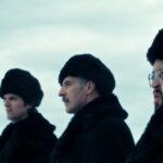 Scene from Apple show "Severance"; 4 people in heavy fur hats