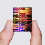 Researcher holding IBM’s sub-1 nm node chip.