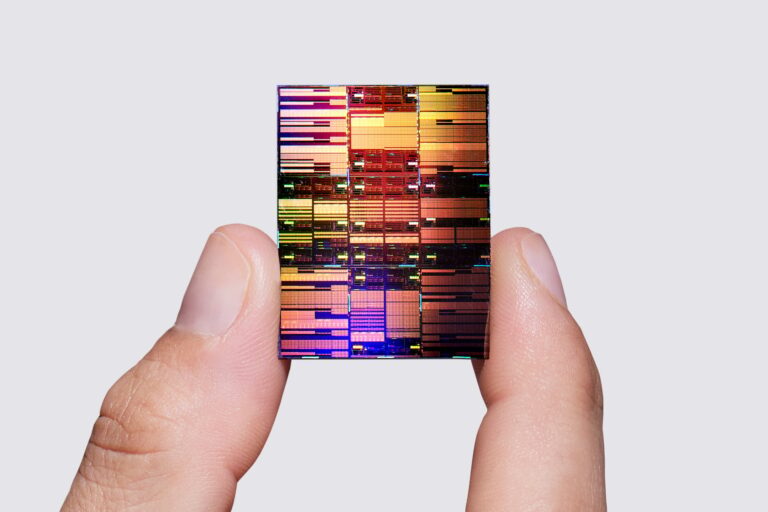 Researcher holding IBM’s sub-1 nm node chip.