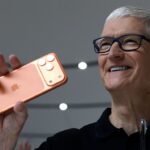 Apple CEO Tim Cook holds up a new iPhone 17 Pro
