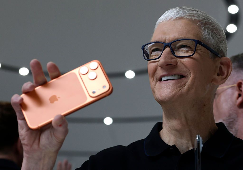 Apple CEO Tim Cook holds up a new iPhone 17 Pro