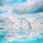 Clock,that,goes,into,the,water.,cloudy,sky.,reflection.,time