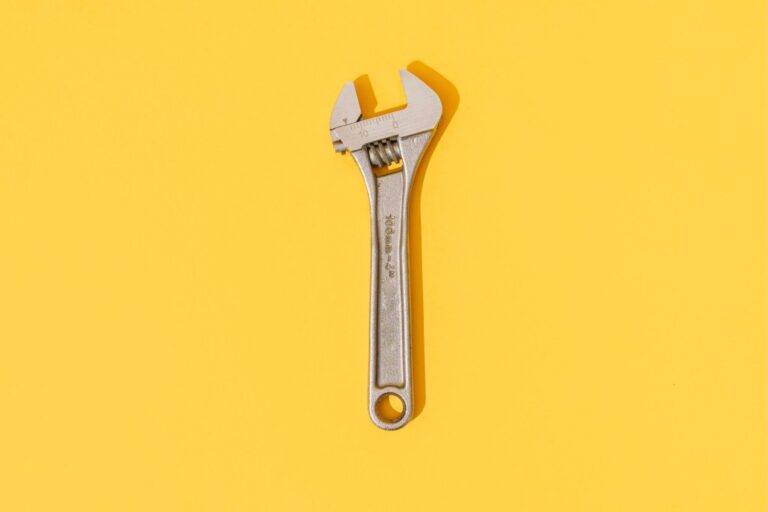 Adjustable wrench on yellow background