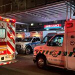 Multiple Ambulances parked outside an emergency room.