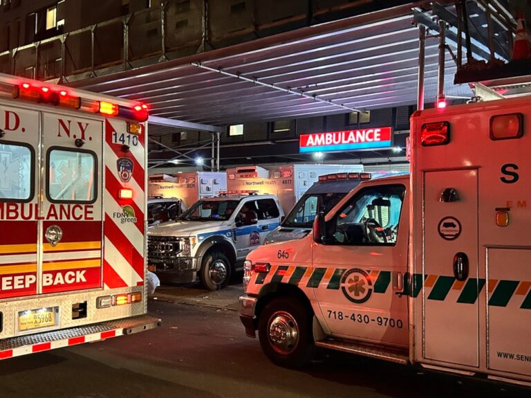 Multiple Ambulances parked outside an emergency room.