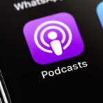 Apple iPhone with Podcasts icon app on screen