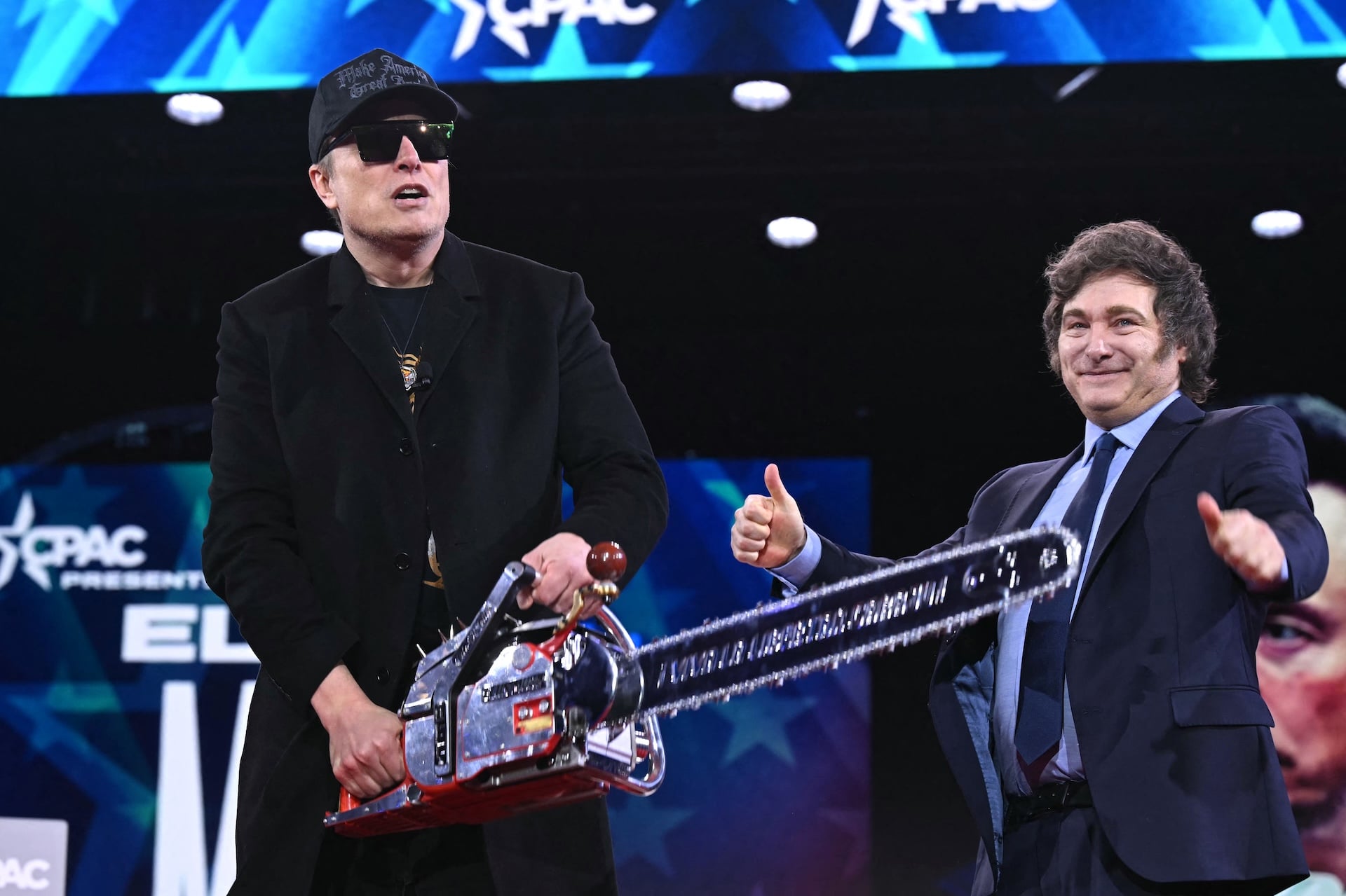 Elon Musk (L) holds a chainsaw alongside Argentine President Javier Milei during the annual Conservative Political Action Conference (CPAC) at the Gaylord National Resort & Convention Center at National Harbor in Oxon Hill, Maryland, on February 20, 2025.