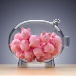 glass piggy bank full of little pink piggies