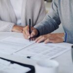 Cropped shot of a senior couple meeting with a consultant to discuss paperwork at home