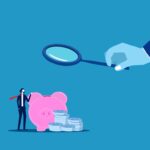 render of hand holding magnifying glass to examine piggy bank.