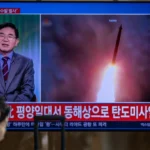 TOPSHOT - News coverage showing file footage of a North Korean missile launch is seen on a screen at Seoul Station in Seoul on October 12, 2026. North Korea on October 12 fired multiple ballistic missiles off its east coast, Seoul's military said, after weeks of mounting friction over a landmine explosion along the countries' heavily fortified border. (Photo by Philip FONG / AFP via Getty Images)