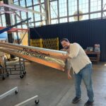 Longshot CEO and cofounder Mike Grace with a projectile designed to be fired from his company's enormous gun.